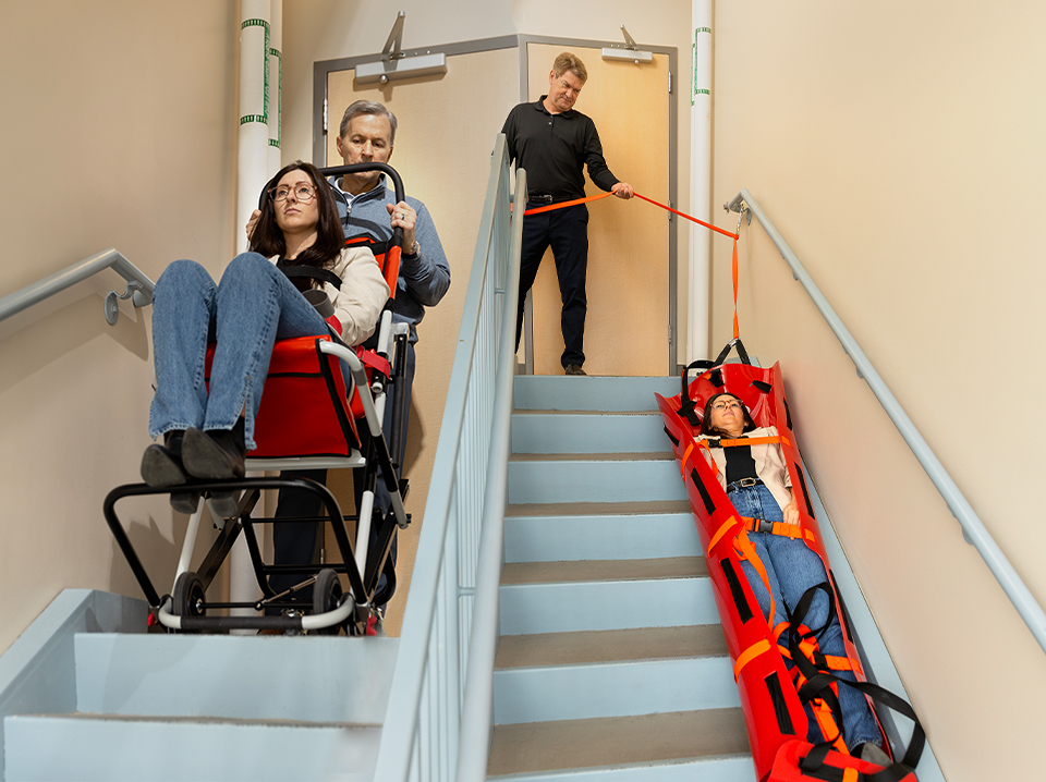 Image showing the evacuation chair and the Med Sled® in use, down stairs in a hospital